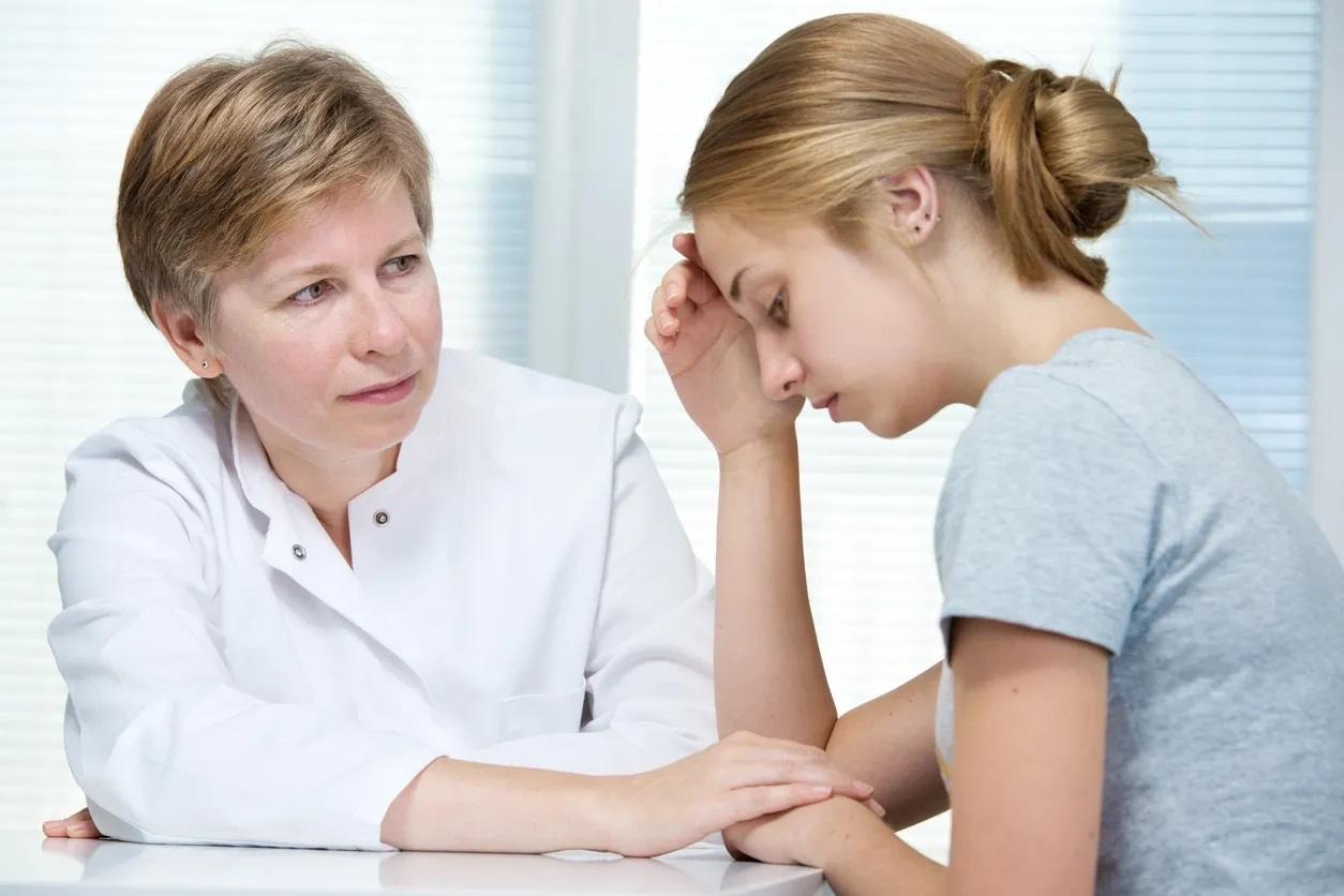 Young professional receiving Telehealth counselling from a psychologist in a South Yarra apartment.