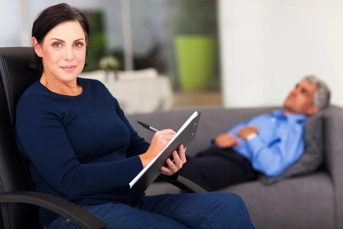 Bunbury woman smiling during a video counselling session at home.